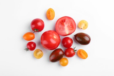 Photo of Flat lay composition with different whole and cut tomatoes on white background