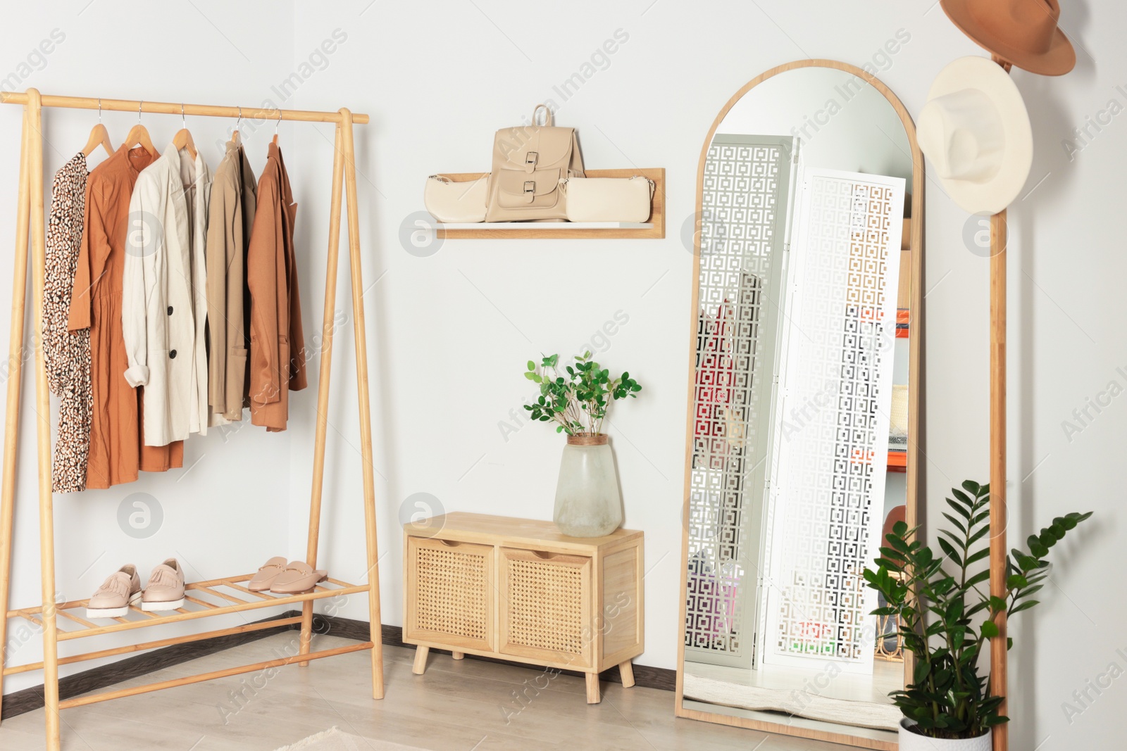 Photo of Modern hallway room interior with large mirror and clothing rack