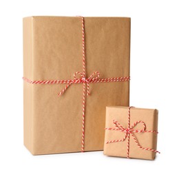 Photo of Gift boxes wrapped in kraft paper with bows on white background