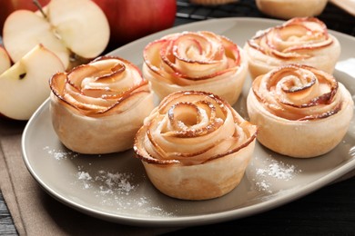 Freshly baked apple roses on plate, closeup. Beautiful dessert