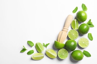 Photo of Flat lay composition with lime, mint and juicer on light background. Refreshing beverage ingredients