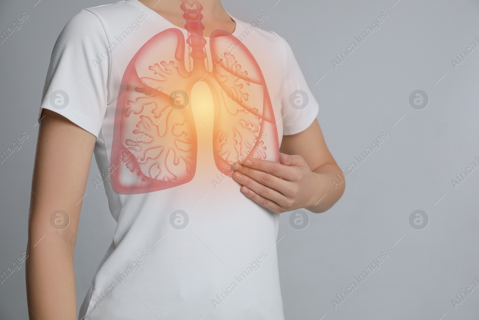 Image of Woman holding hand near chest with illustration of lungs on light grey background, closeup