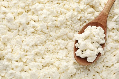 Photo of Delicious fresh cottage cheese and spoon as background, top view