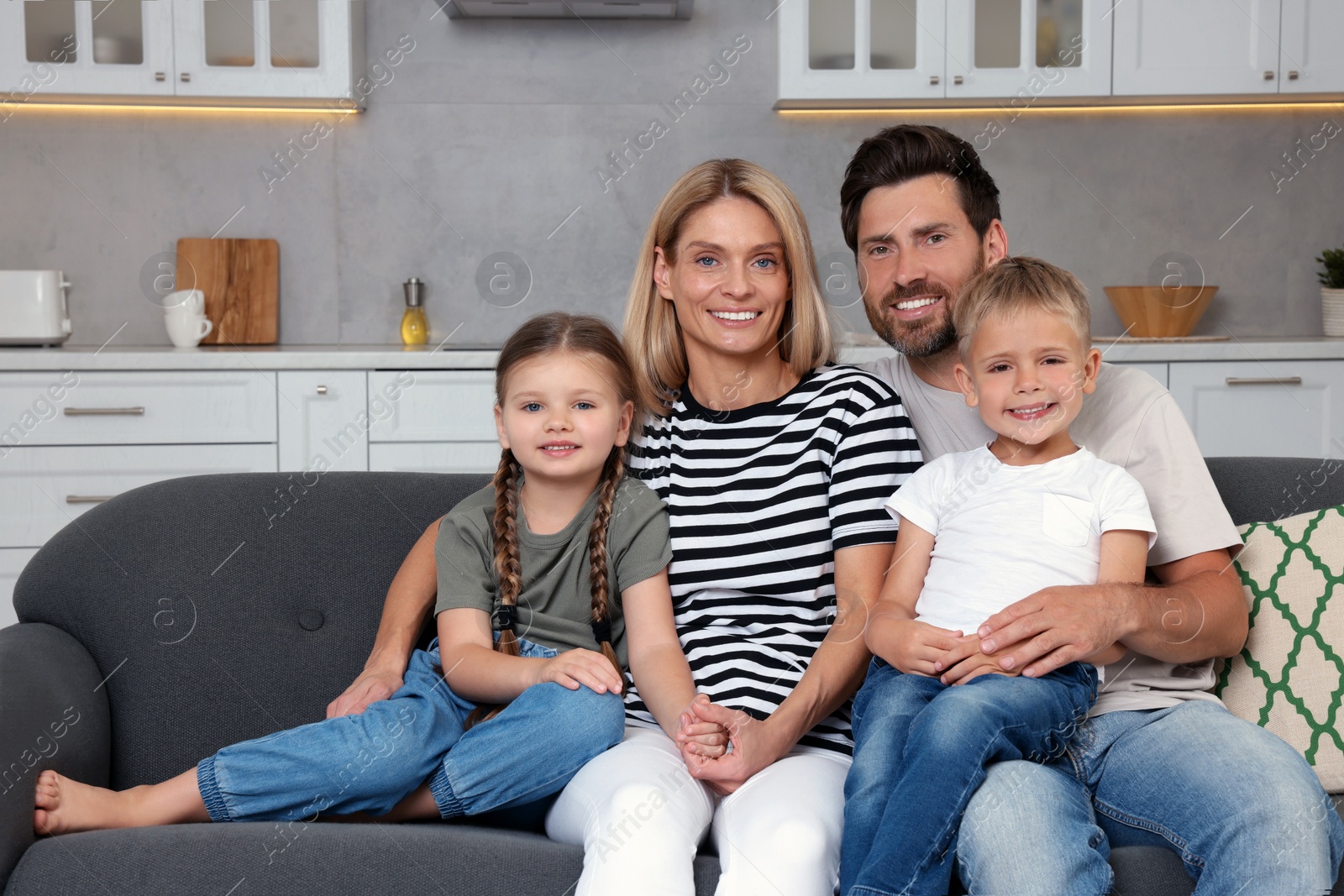 Photo of Portrait of happy family with children on sofa at home