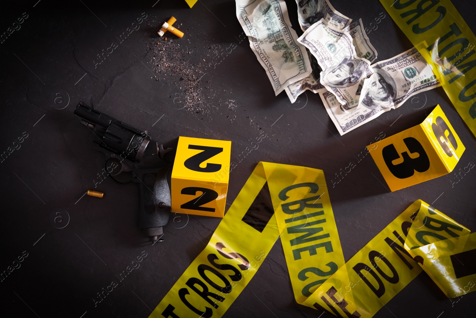 Photo of Flat lay composition with evidences and crime scene markers on black background