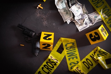 Flat lay composition with evidences and crime scene markers on black background