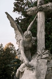 Photo of Beautiful statue of angel on cemetery. Funeral ceremony
