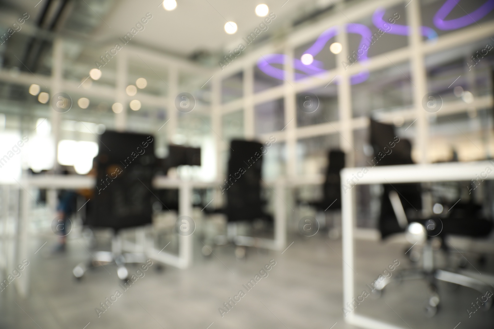 Photo of Blurred view of cozy workspaces with tables and chairs in office