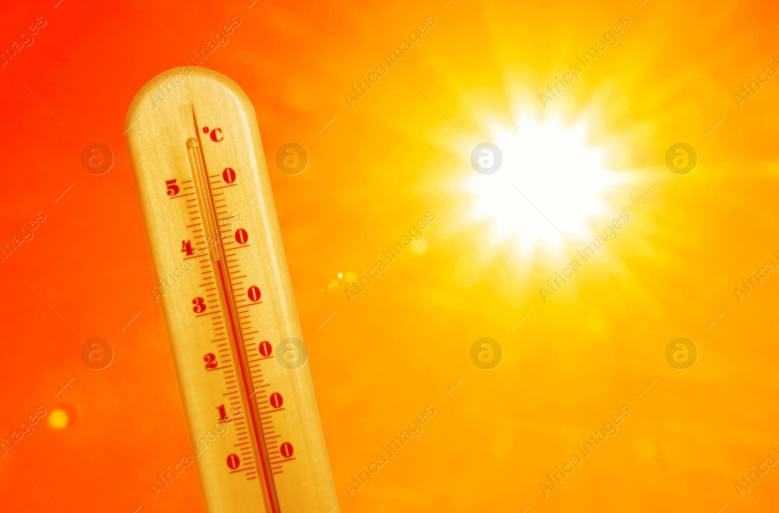 Image of Weather thermometer with high temperature outdoors on hot sunny day. Heat stroke warning