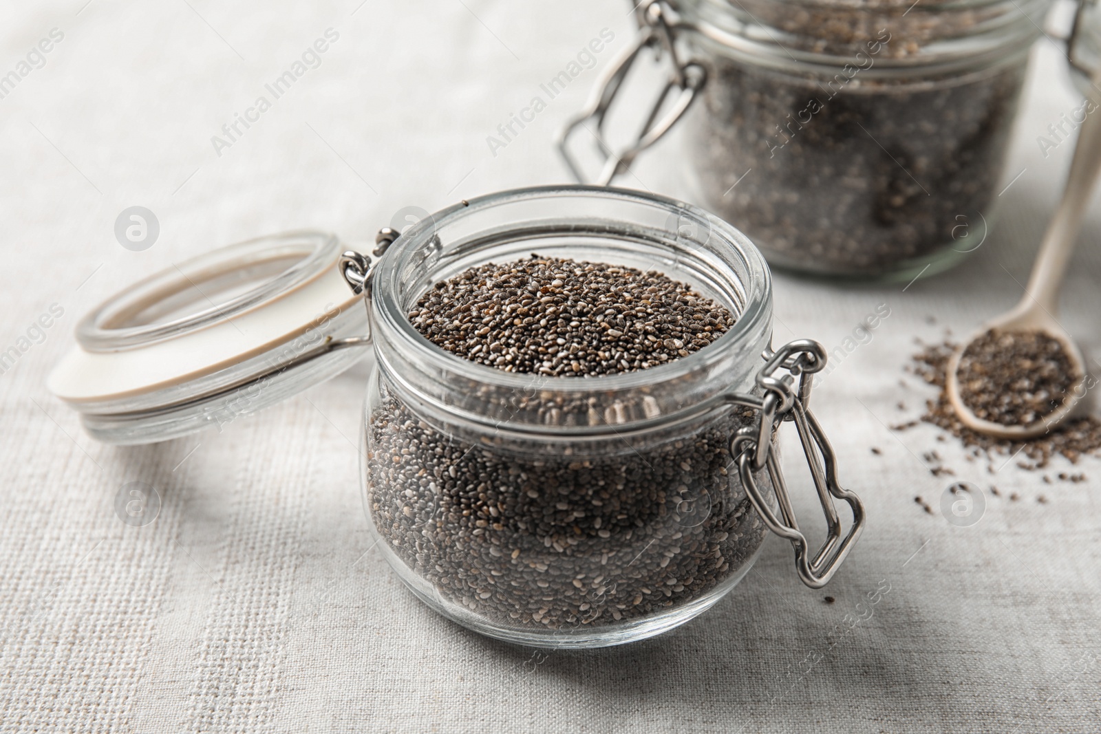 Photo of Glass jar with chia seeds on fabric