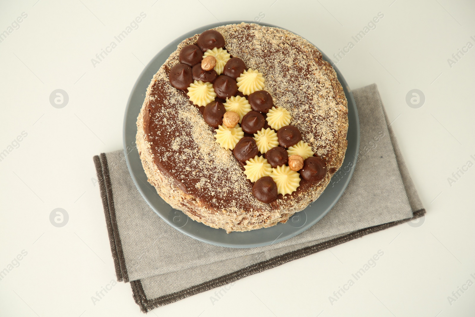 Photo of Delicious Kyiv Cake decorated with cream on white table, above view