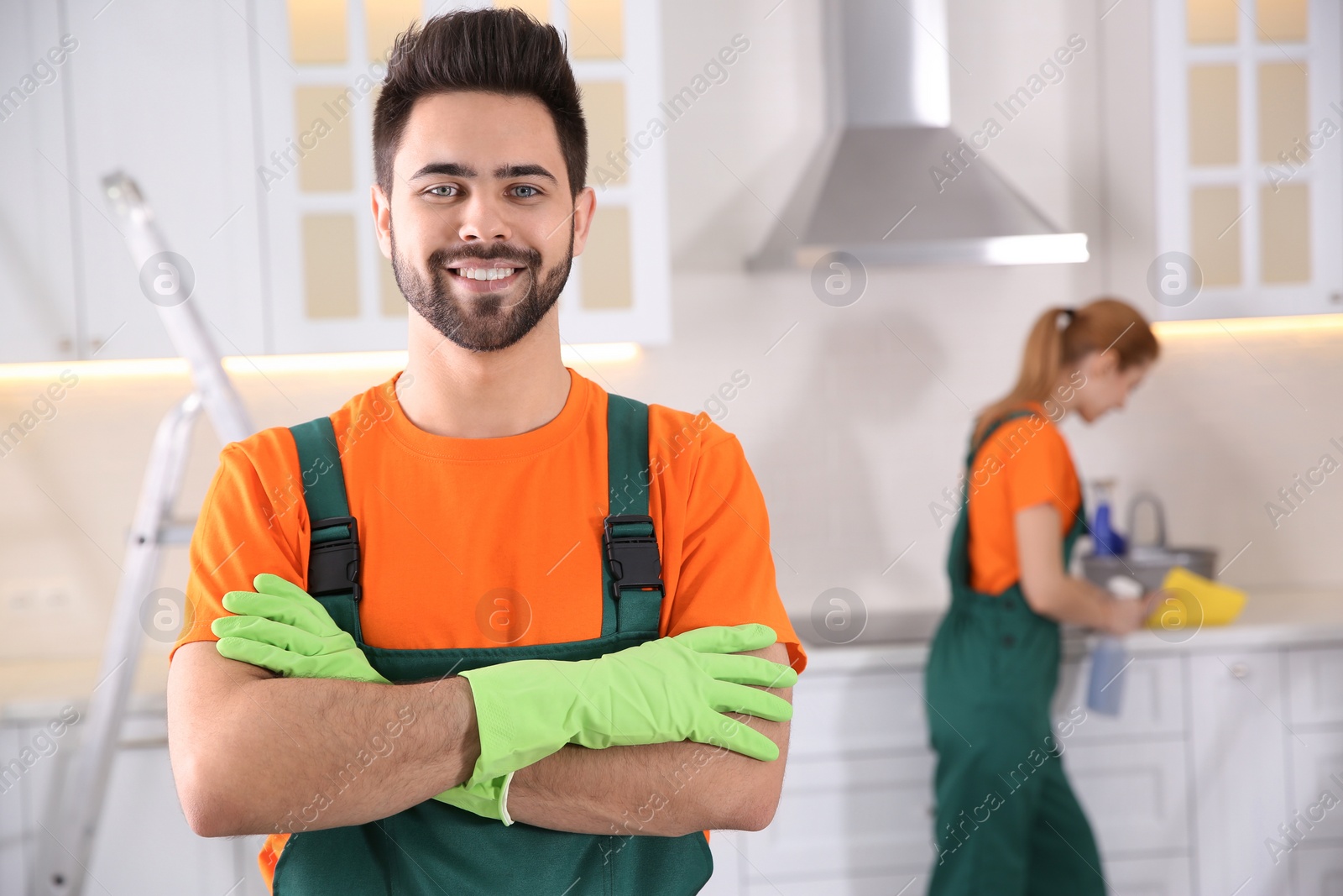 Photo of Professional janitor in uniform indoors. Cleaning service