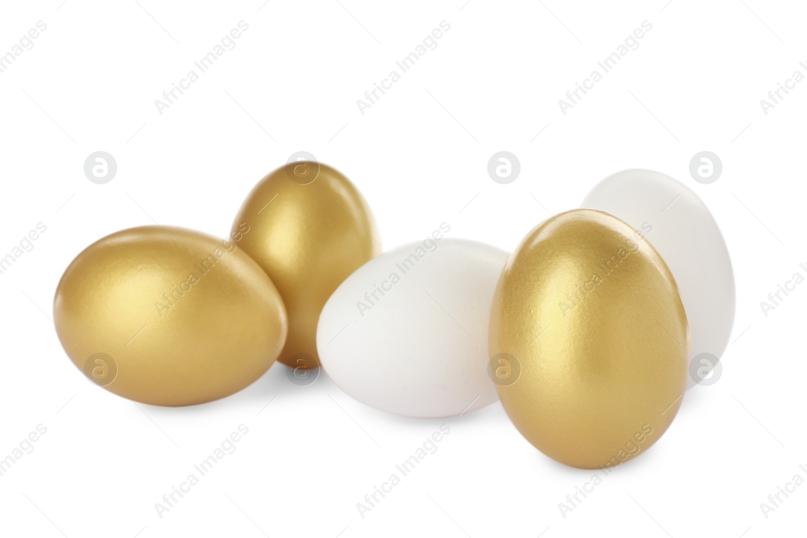 Photo of Golden eggs among ordinary ones on white background