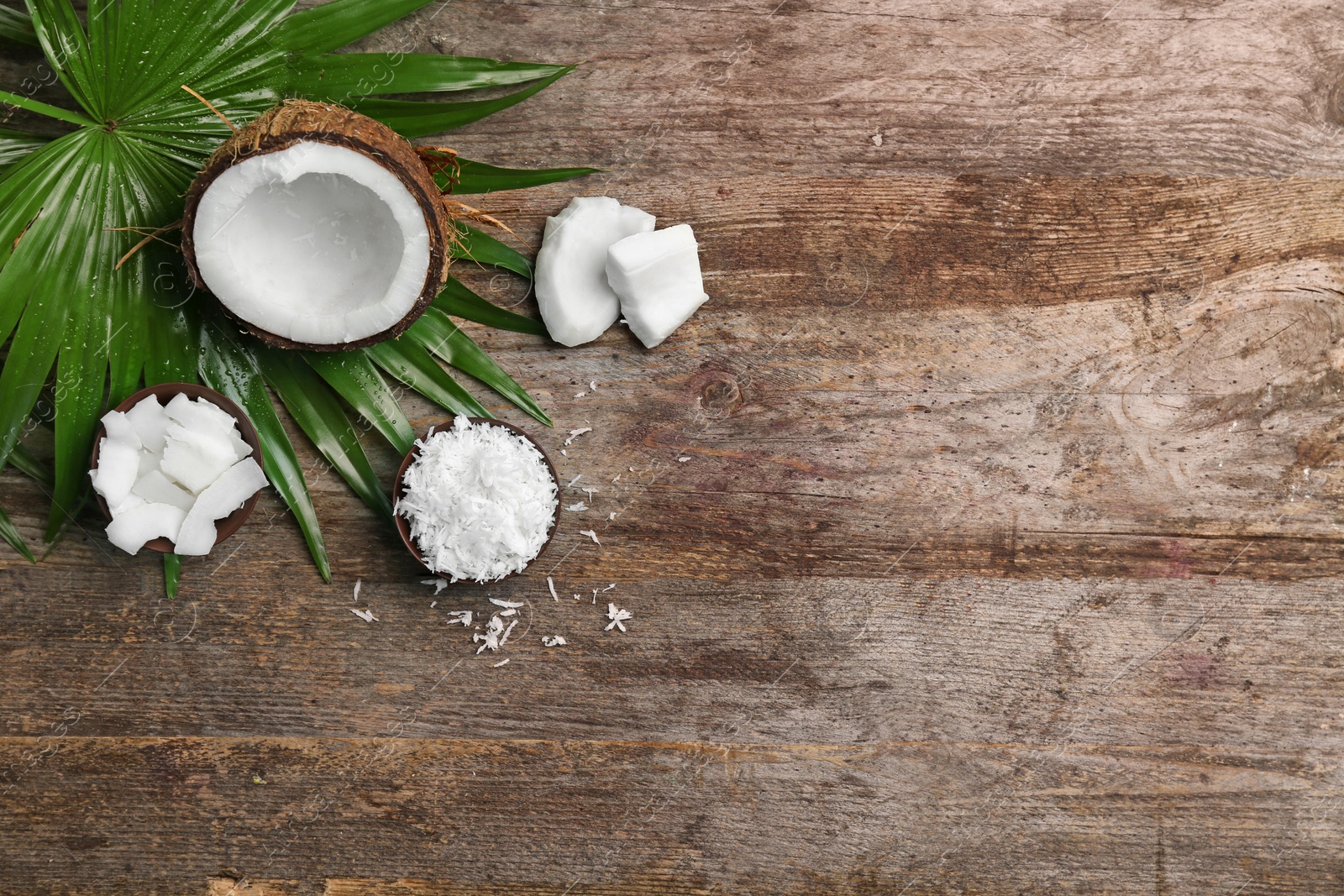 Photo of Composition with fresh coconut flakes on wooden background, top view