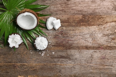 Composition with fresh coconut flakes on wooden background, top view