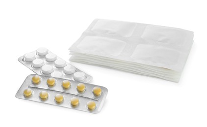Photo of Stack of mustard plasters and pills on white background