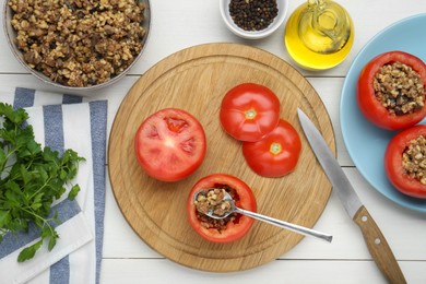 Photo of Preparing stuffed tomatoes with minced beef, bulgur and mushrooms on white wooden table, flat lay