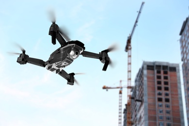 Image of Modern drone flying at building site. Aerial survey