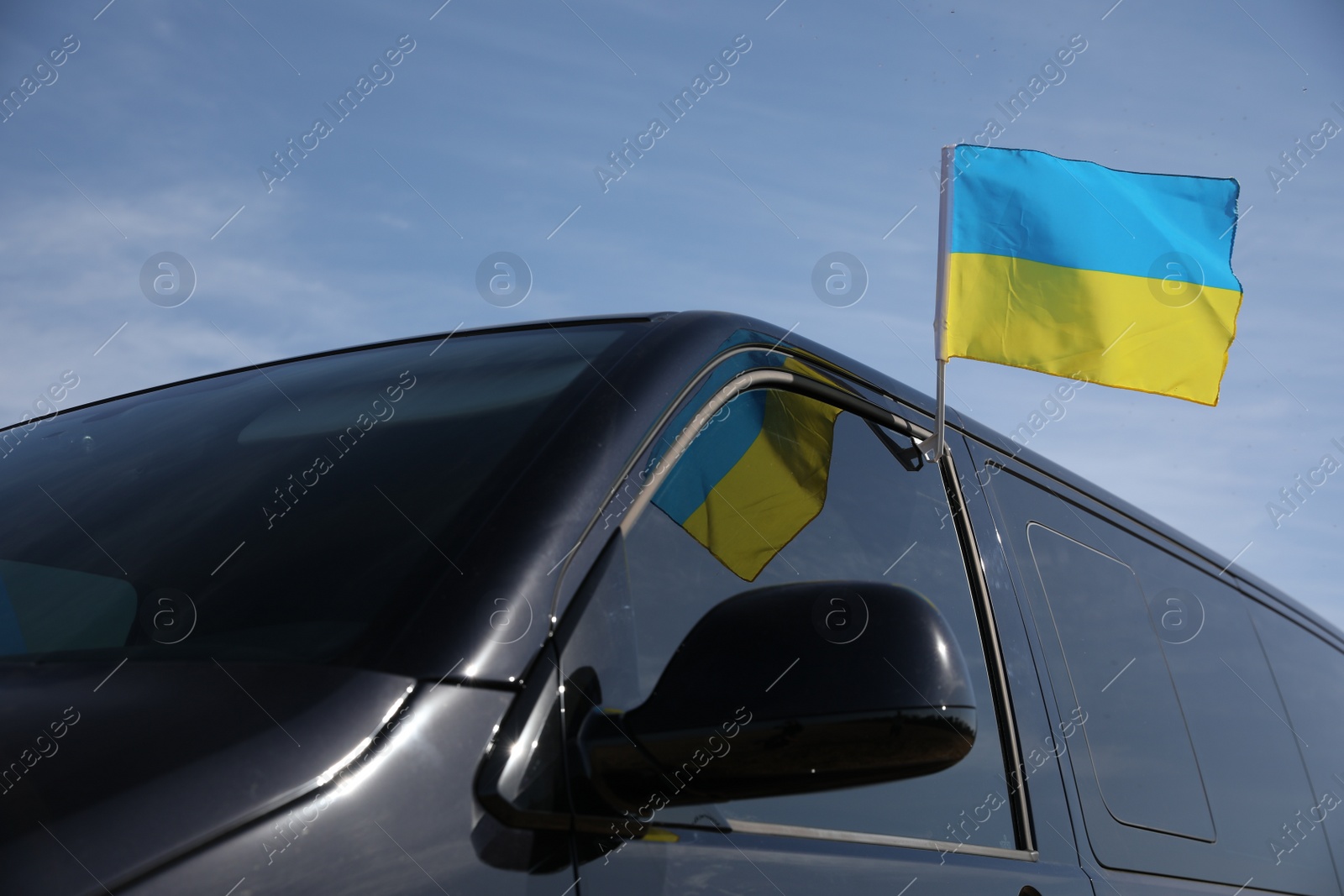 Photo of National flag of Ukraine on car window outdoors