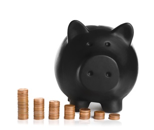 Photo of Piggy bank and different height coin stacks on white background