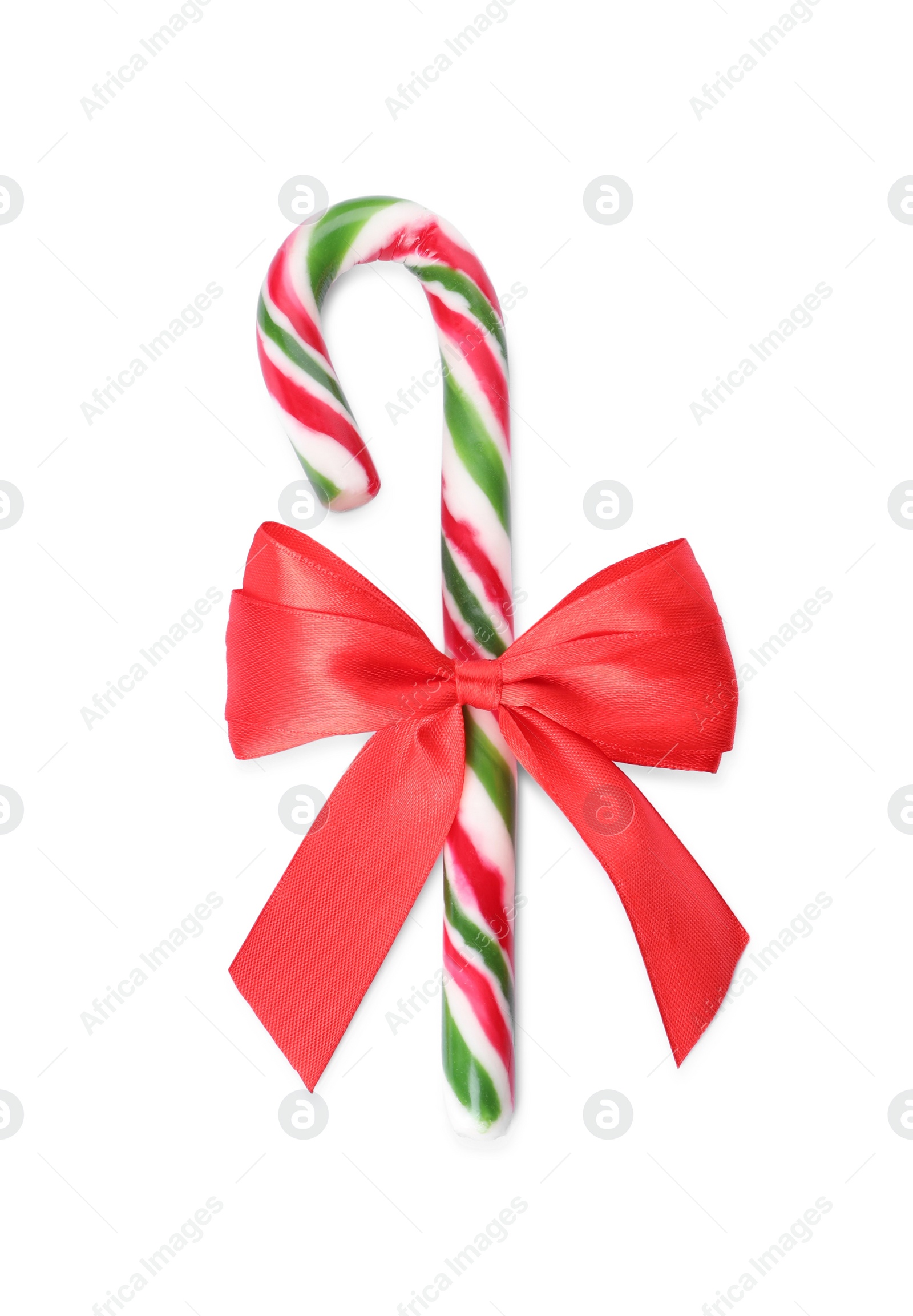 Photo of Sweet Christmas candy cane with red bow on white background, top view