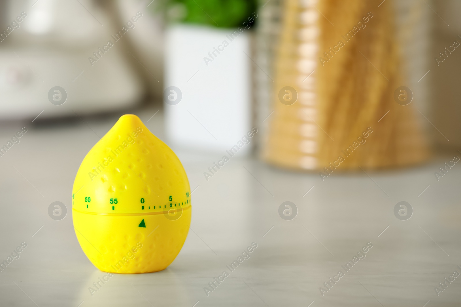 Photo of Kitchen timer in shape of lemon on white table indoors. Space for text