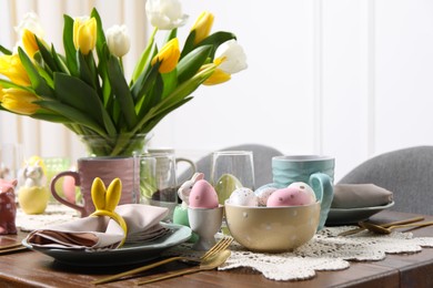 Festive table setting with beautiful flowers. Easter celebration