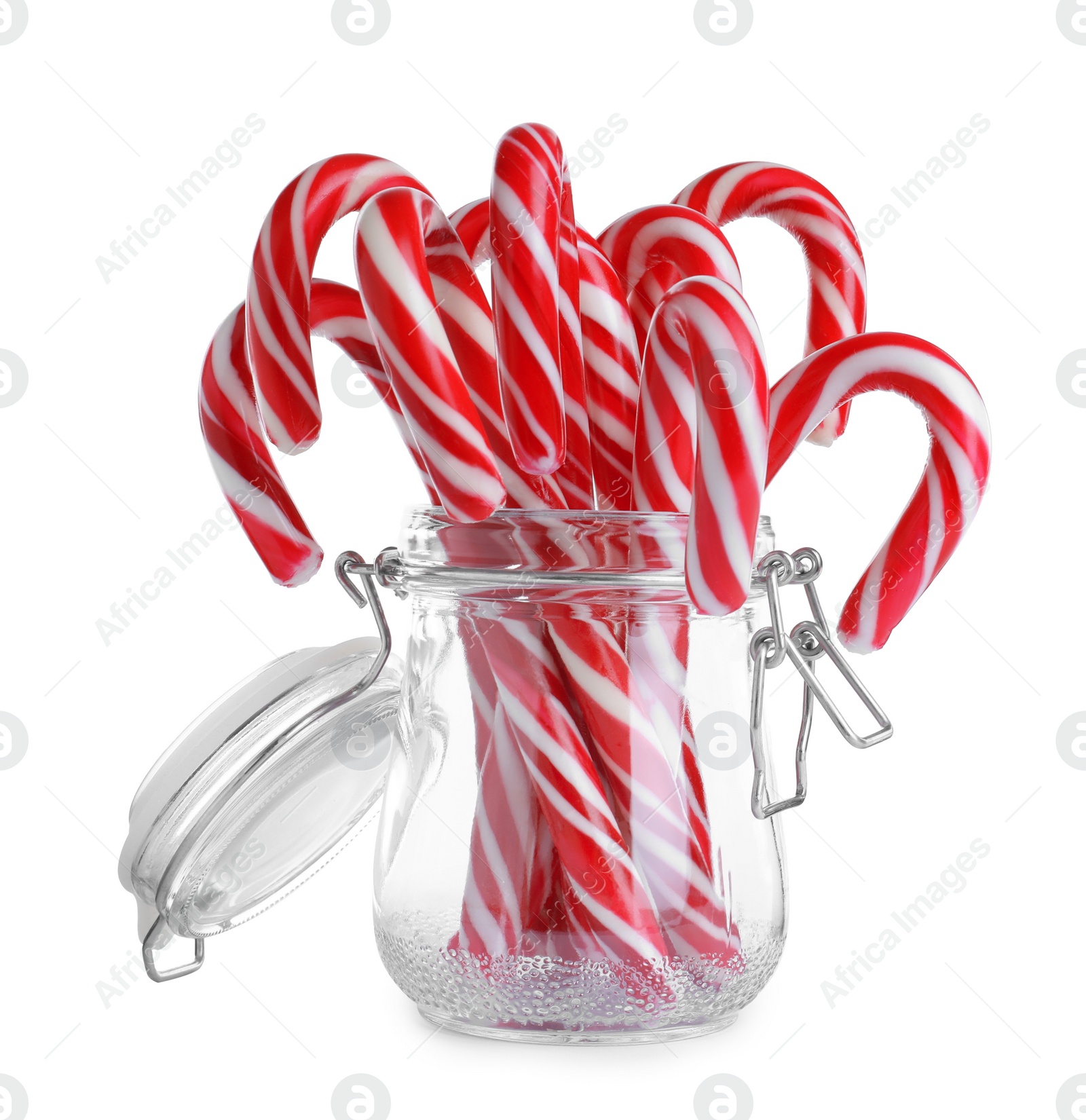 Photo of Glass jar with sweet Christmas candy canes on white background
