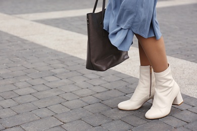 Photo of Woman in stylish leather shoes with bag outdoors, closeup
