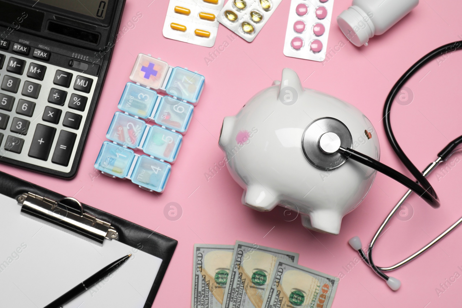 Photo of Flat lay composition with piggy bank and stethoscope on pink background. Medical insurance