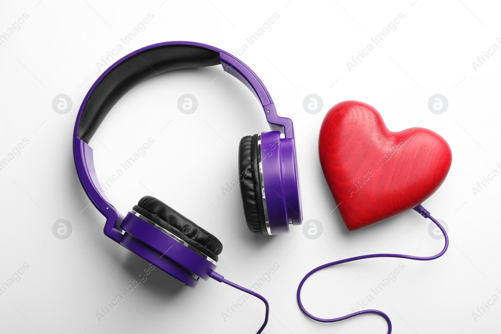 Photo of Decorative heart and modern headphones on white background, top view