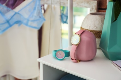 Photo of Table with beautiful wristwatches in dressing room