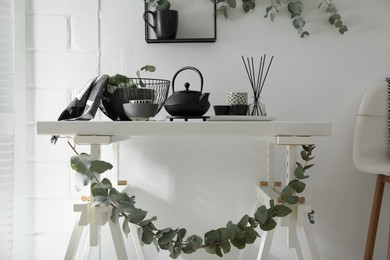 Photo of Stylish room decorated with beautiful green eucalyptus branches