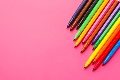 Photo of Many bright markers on pink background, flat lay. Space for text