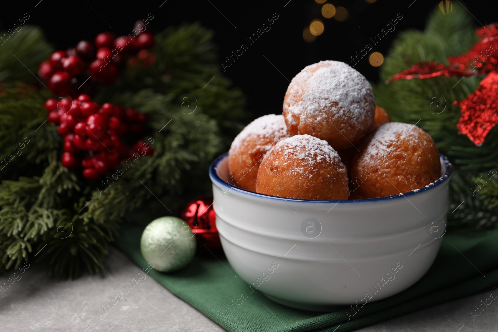 Photo of Delicious sweet buns in bowl and decor on table, closeup