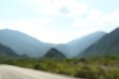 Photo of Blurred view of mountains and empty asphalt highway outdoors. Road trip