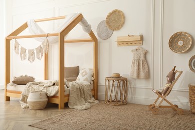 Stylish child room interior with house bed