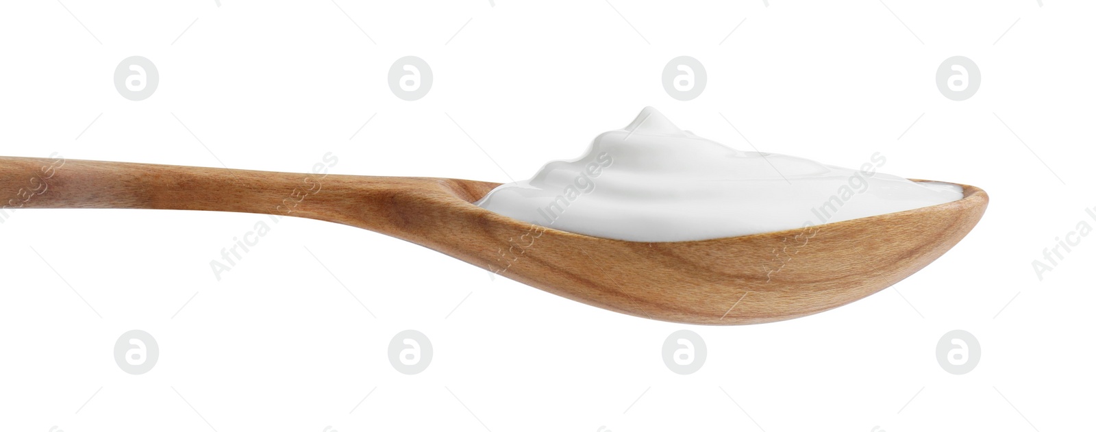 Photo of One wooden spoon with sour cream isolated on white