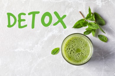 Image of Word Detox and glass of delicious juice on light table, top view