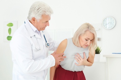 Photo of Senior woman having heart attack in clinic