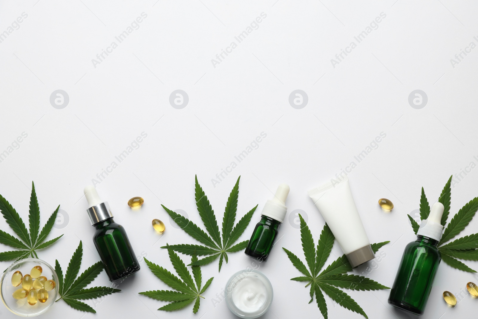 Photo of Flat lay composition with hemp leaves, CBD oil and THC tincture on white background, space for text