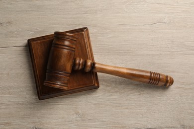 Wooden gavel on light table, top view