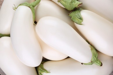 Fresh white eggplants as background, top view