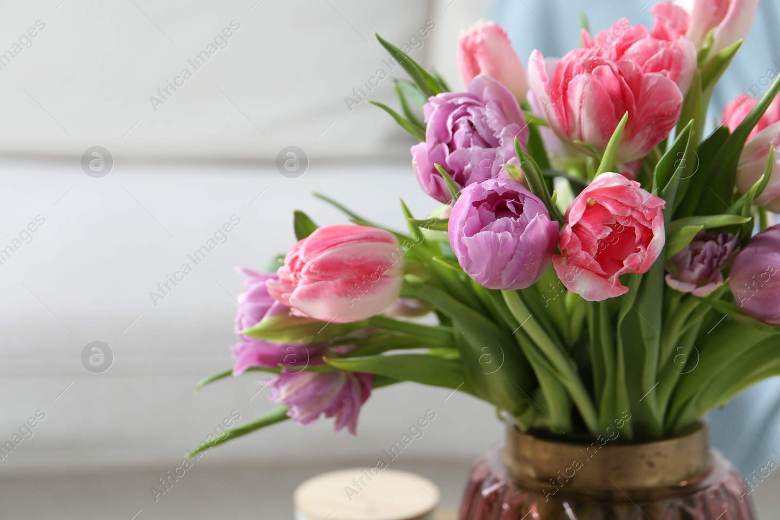 Photo of Beautiful bouquet of colorful tulip flowers indoors, closeup. Space for text