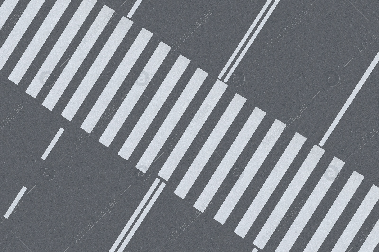 Image of White pedestrian crossing on empty city street, top view