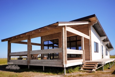 Photo of Wooden house in countryside on sunny day