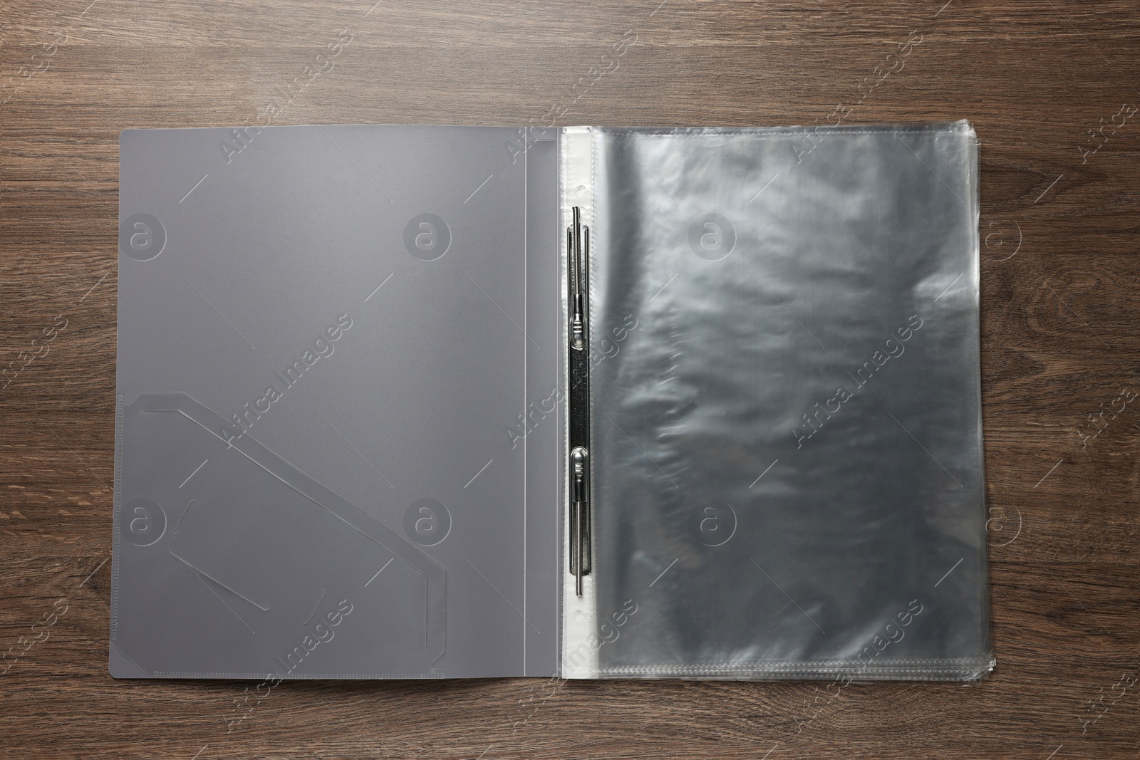 Photo of File folder with punched pockets on wooden table, top view