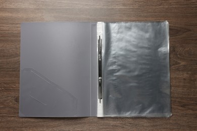 Photo of File folder with punched pockets on wooden table, top view