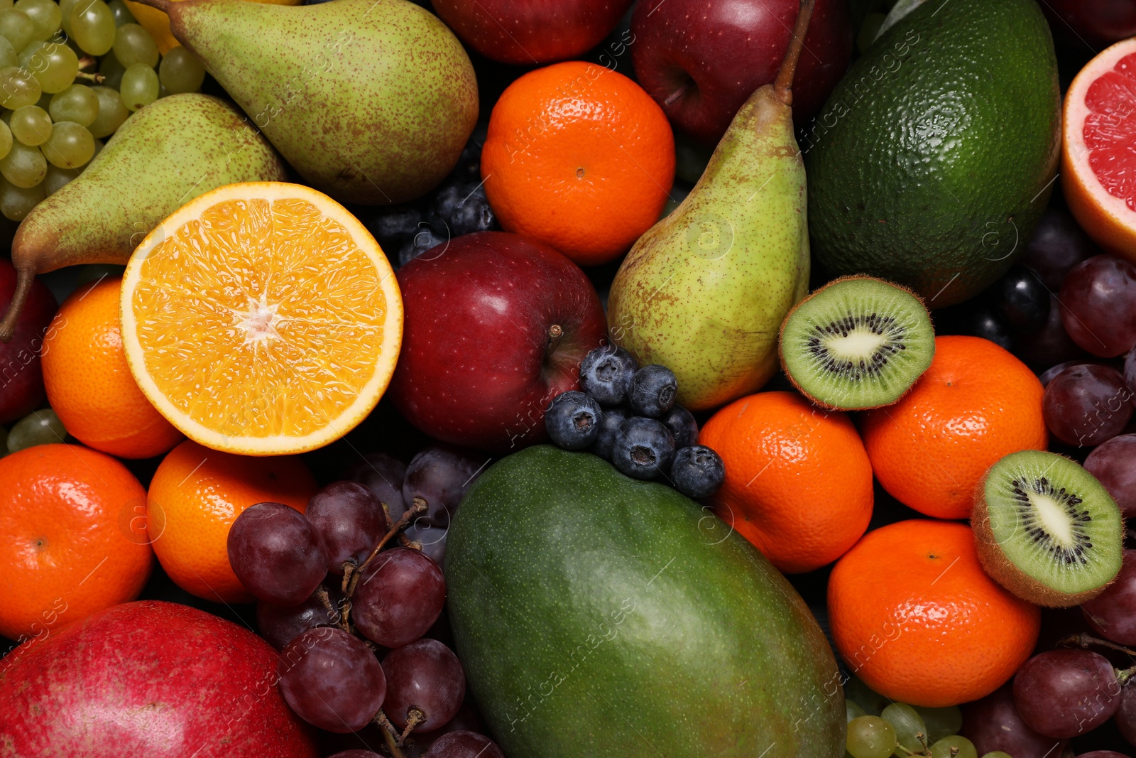 Photo of Different ripe fruits and berries as background, top view