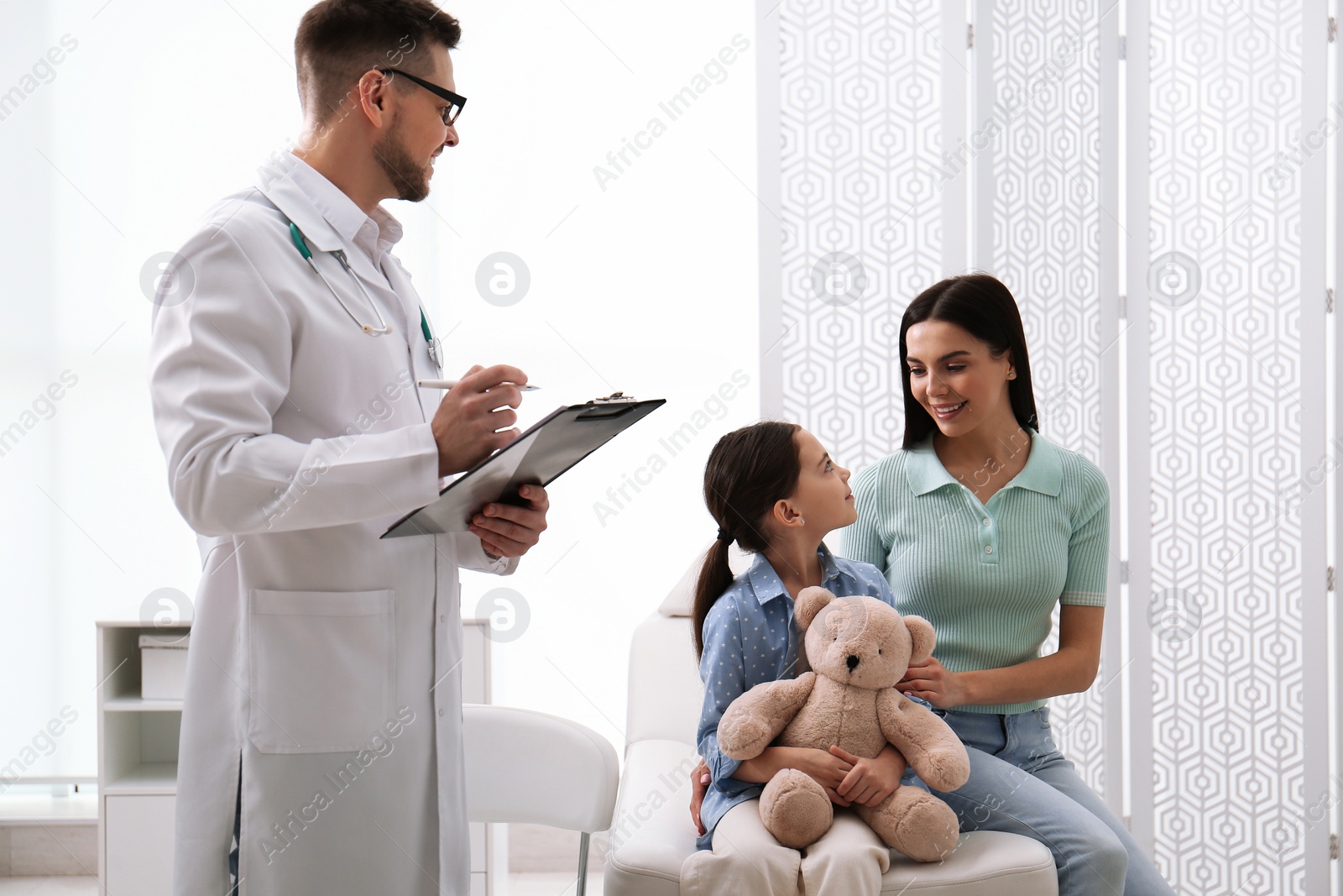 Photo of Mother with daughter visiting pediatrician in hospital